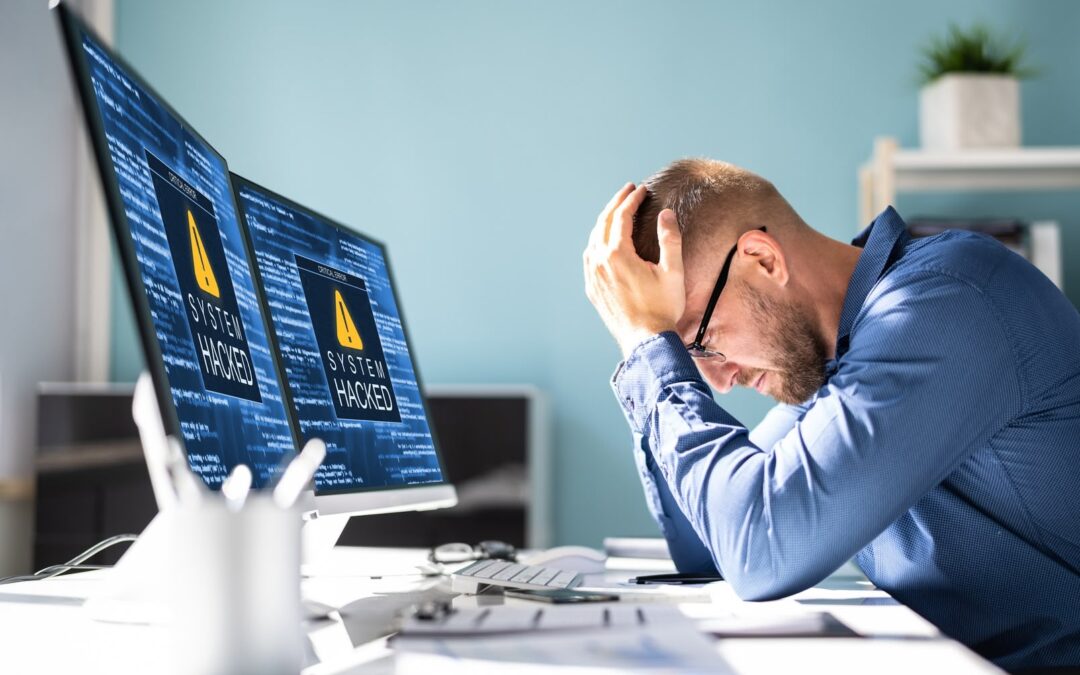 man holding his head because of the recent cyber attacks