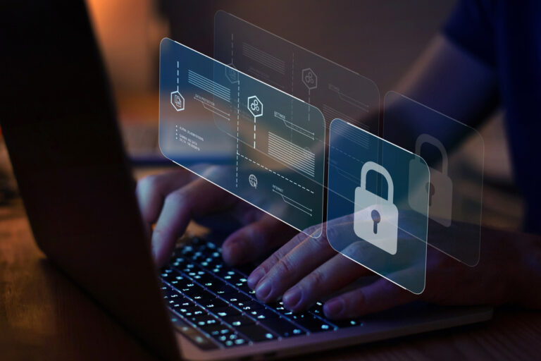 a picture of a computer with a hand of a human in the kyeboard with cybersecurity overlayed