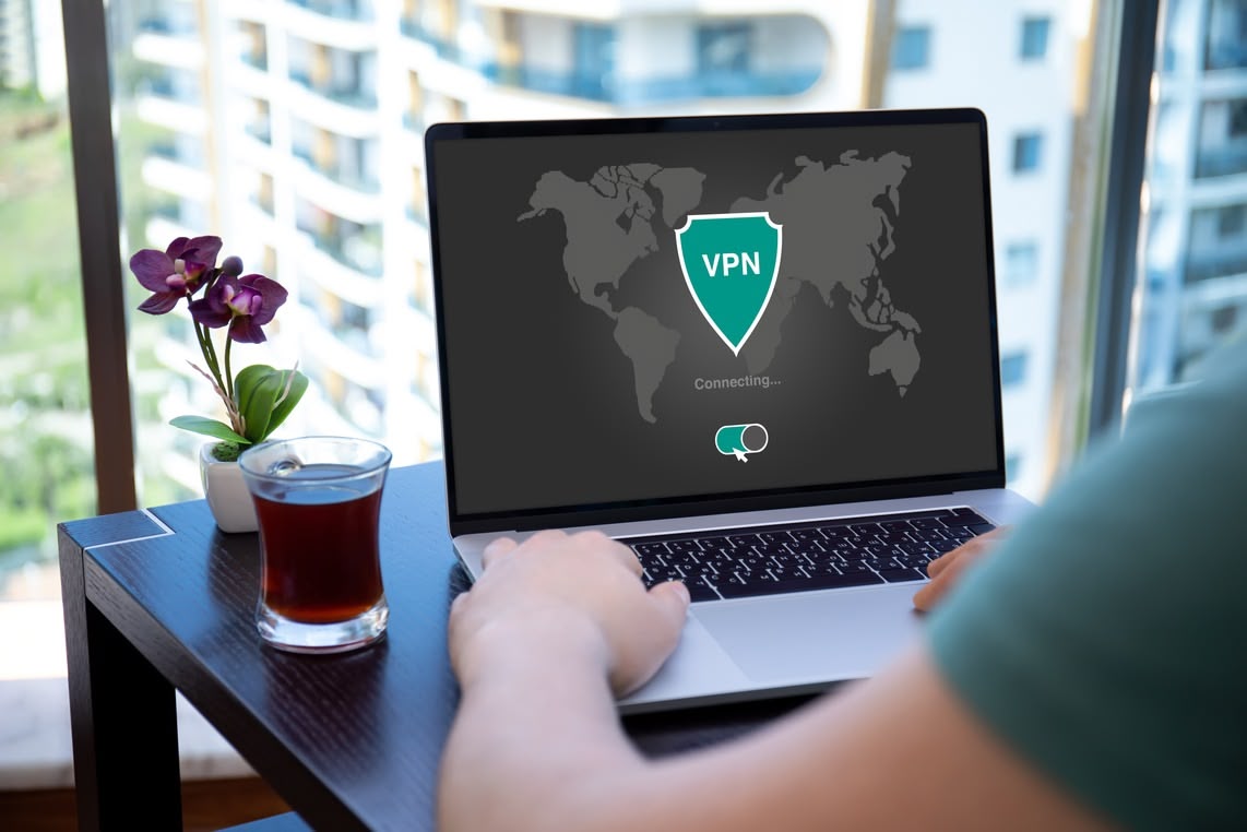 vpn a man using a laptop with a vpn on his screen